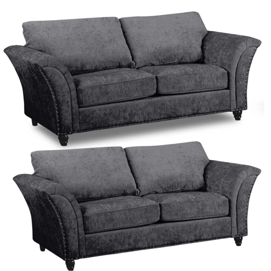 Two identical gray sofas on a white background
