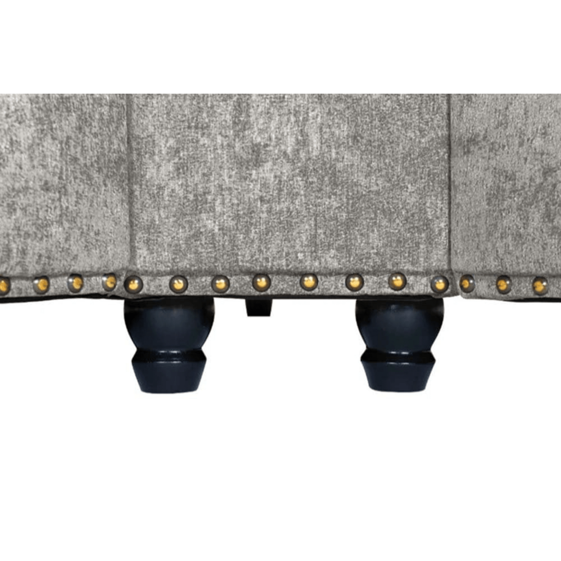 Close-up of a textured fabric surface with decorative studs on a white background