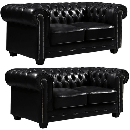 Two black leather sofas with tufted backrests on a white background