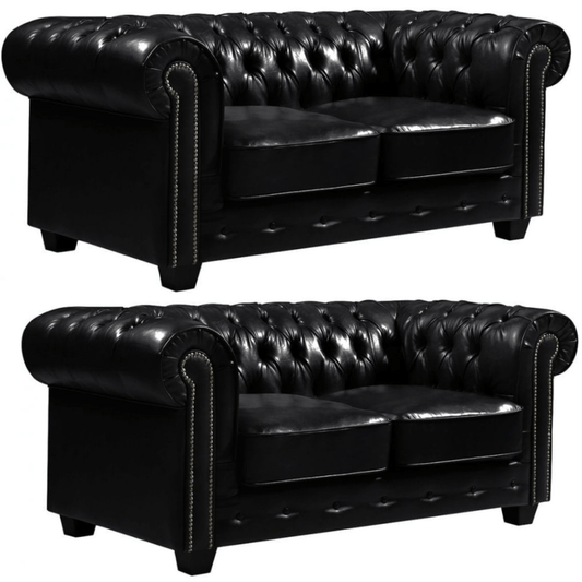 Two black leather sofas with tufted backrests on a white background