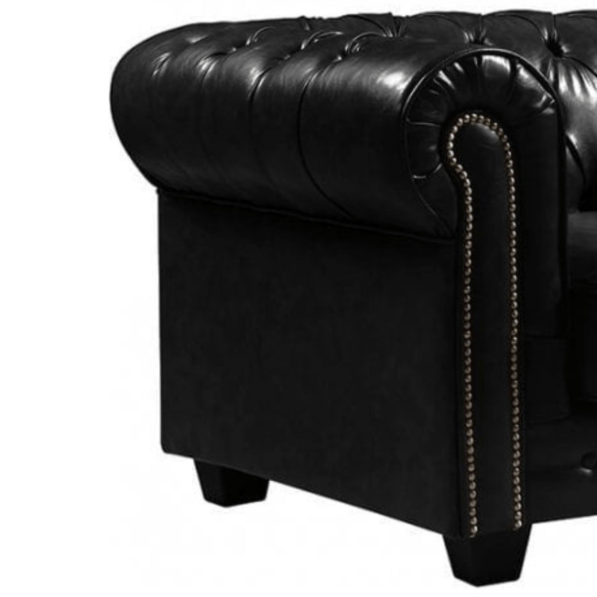 Close-up of a black leather armchair with tufted backrest and nailhead trim on a white background.