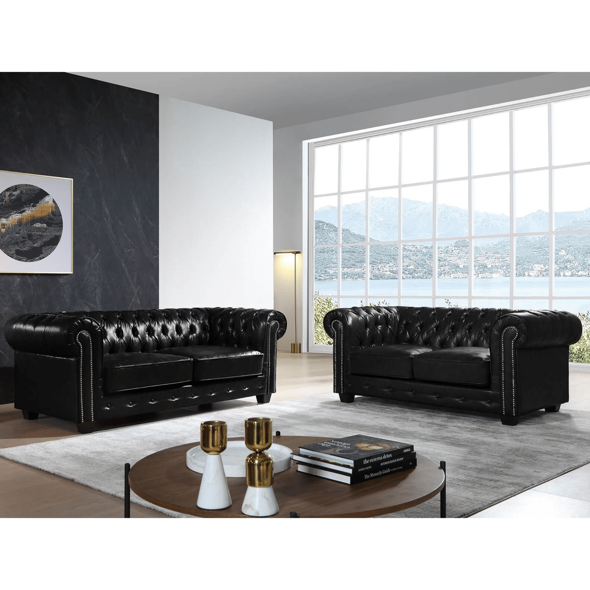 Black leather sofas in a modern living room with large windows.