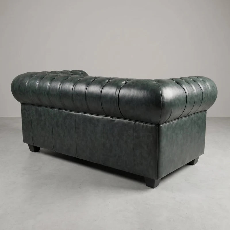 Chesterfield Green Leather Antique 2 seater sofa rear three-quarter studio view on a grey floor