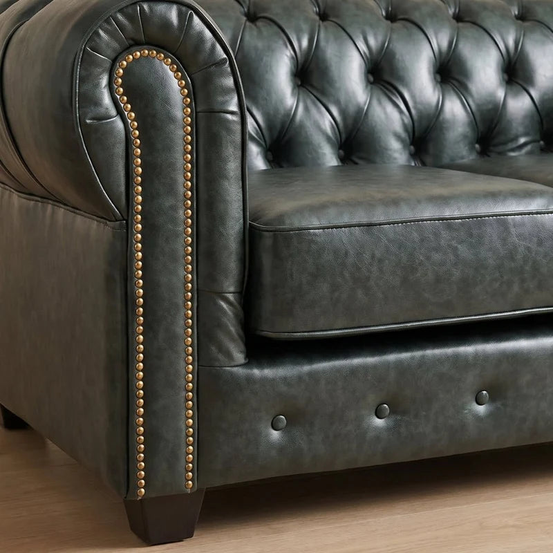 Chesterfield Green Leather Antique 2 seater sofa close-up of the arm, nailhead trim and turned wooden leg