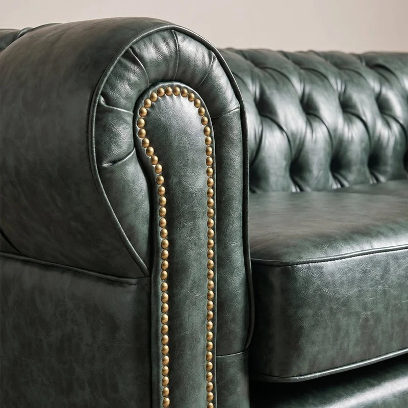 Chesterfield Green Leather Antique 3 seater sofa close-up of the arm roll and brass nailhead trim