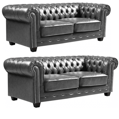 Two gray leather sofas with tufted backrests on a white background