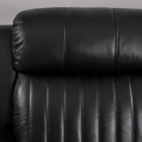 Closeup of Cidliano black 2-seater sofa highlighting fabric texture and craftsmanship on white background.