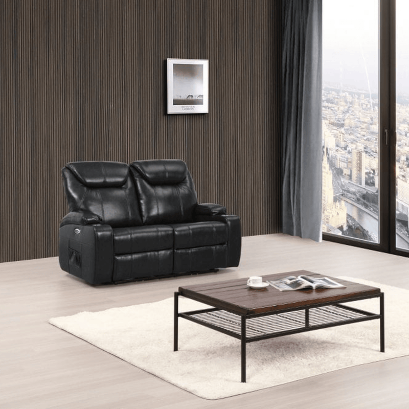 Black leather sofa in a living room with a wooden coffee table and city view.