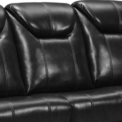 Close-up of a black leather sofa with visible stitching