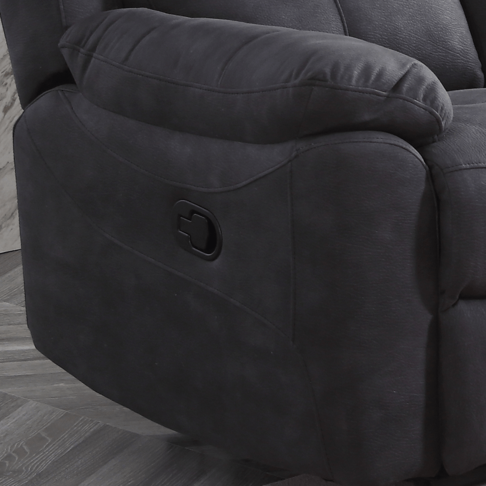 Grey recliner chair with a wooden floor background