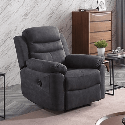 Grey recliner chair in a living room setting with a wooden cabinet and decorative items.
