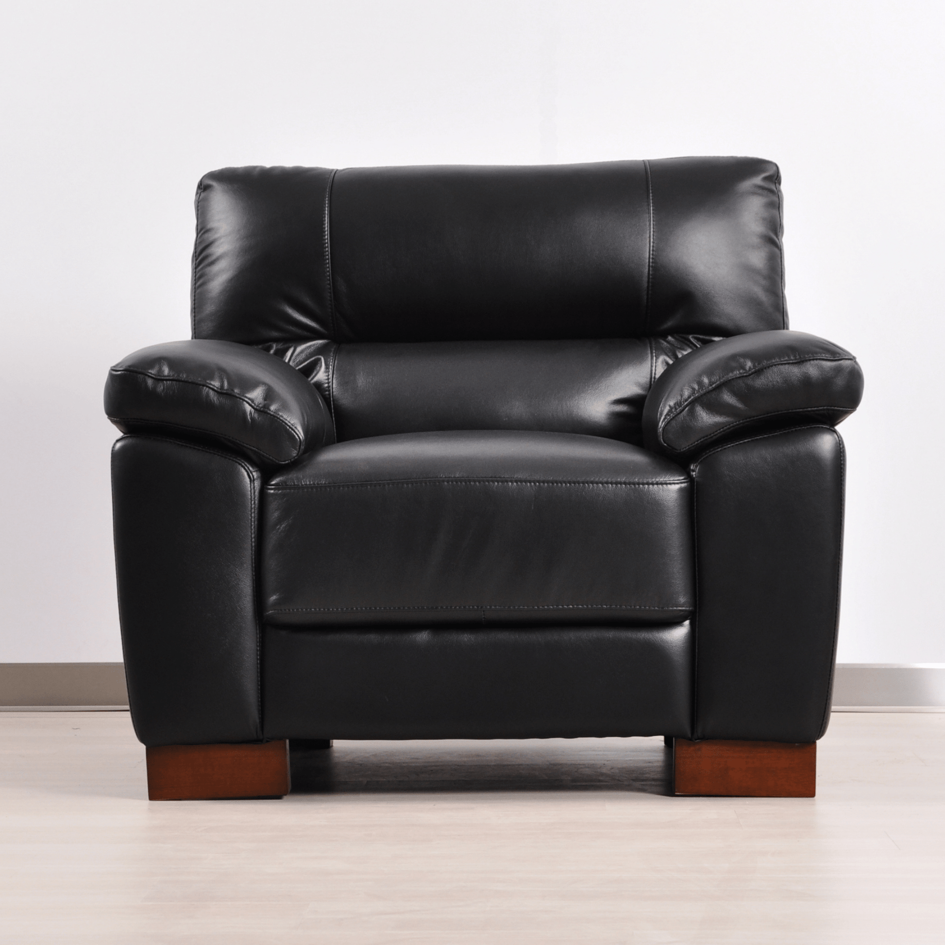 Dalmore Black armchair front facing in room setting with modern sleek design