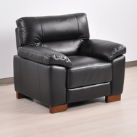 Dalmore Black Armchair – Angled view in a cozy room setting, showcasing plush black upholstery and modern styling.