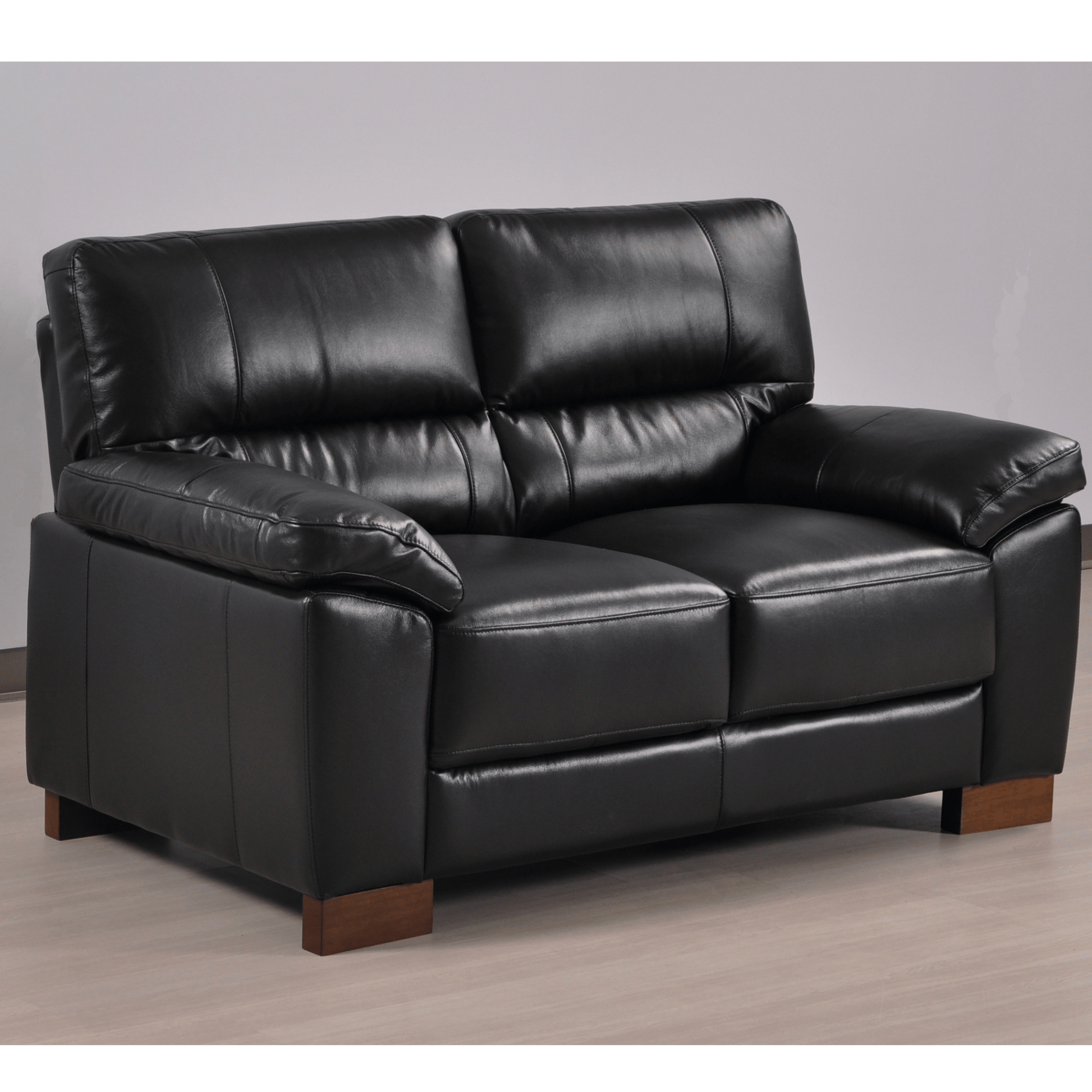 Dalmore Black 2 Seater Sofa – Angled view in a cozy room setting, showcasing plush black fabric and modern styling.