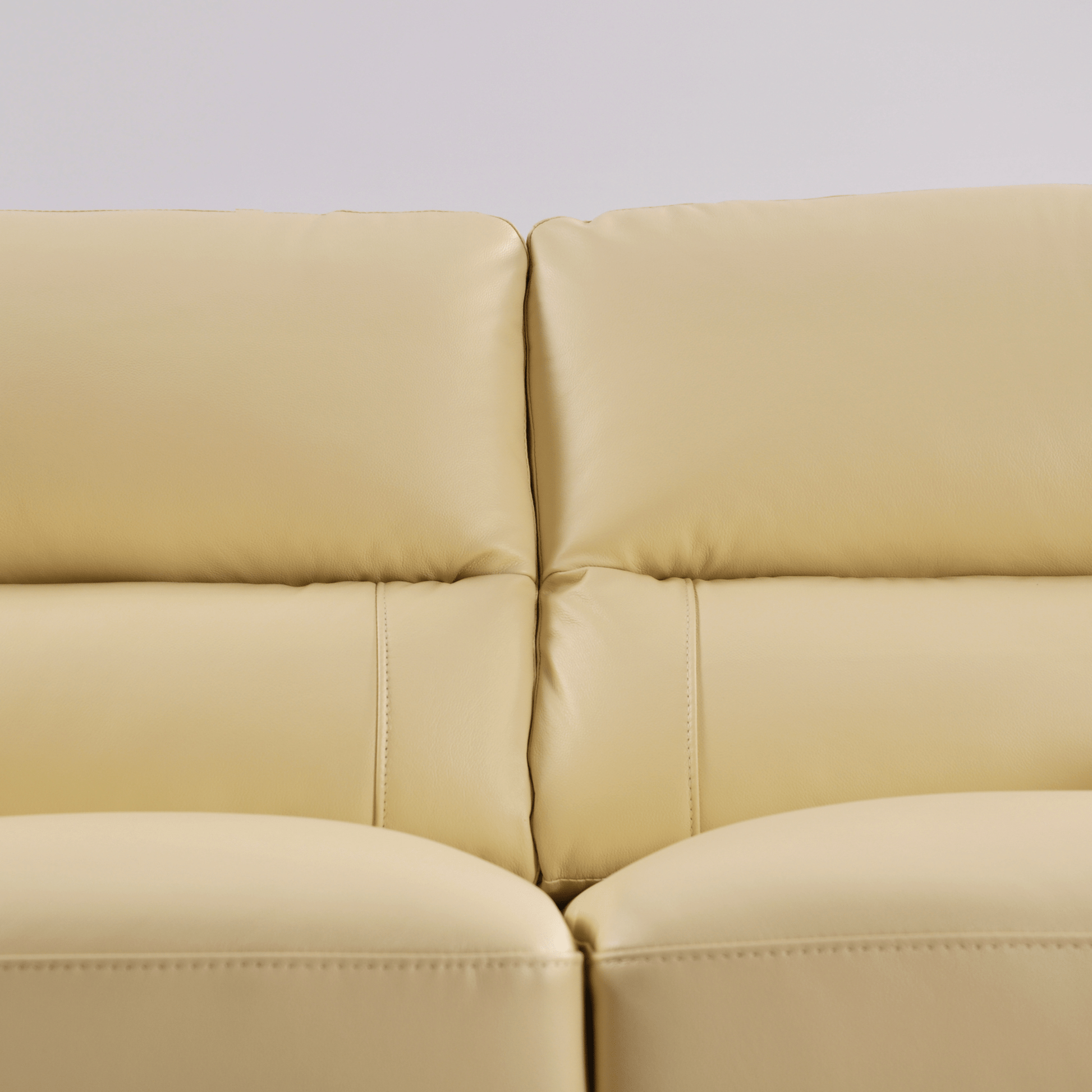 Cream 2-seater sofa close-up view on white background with modern sleek design