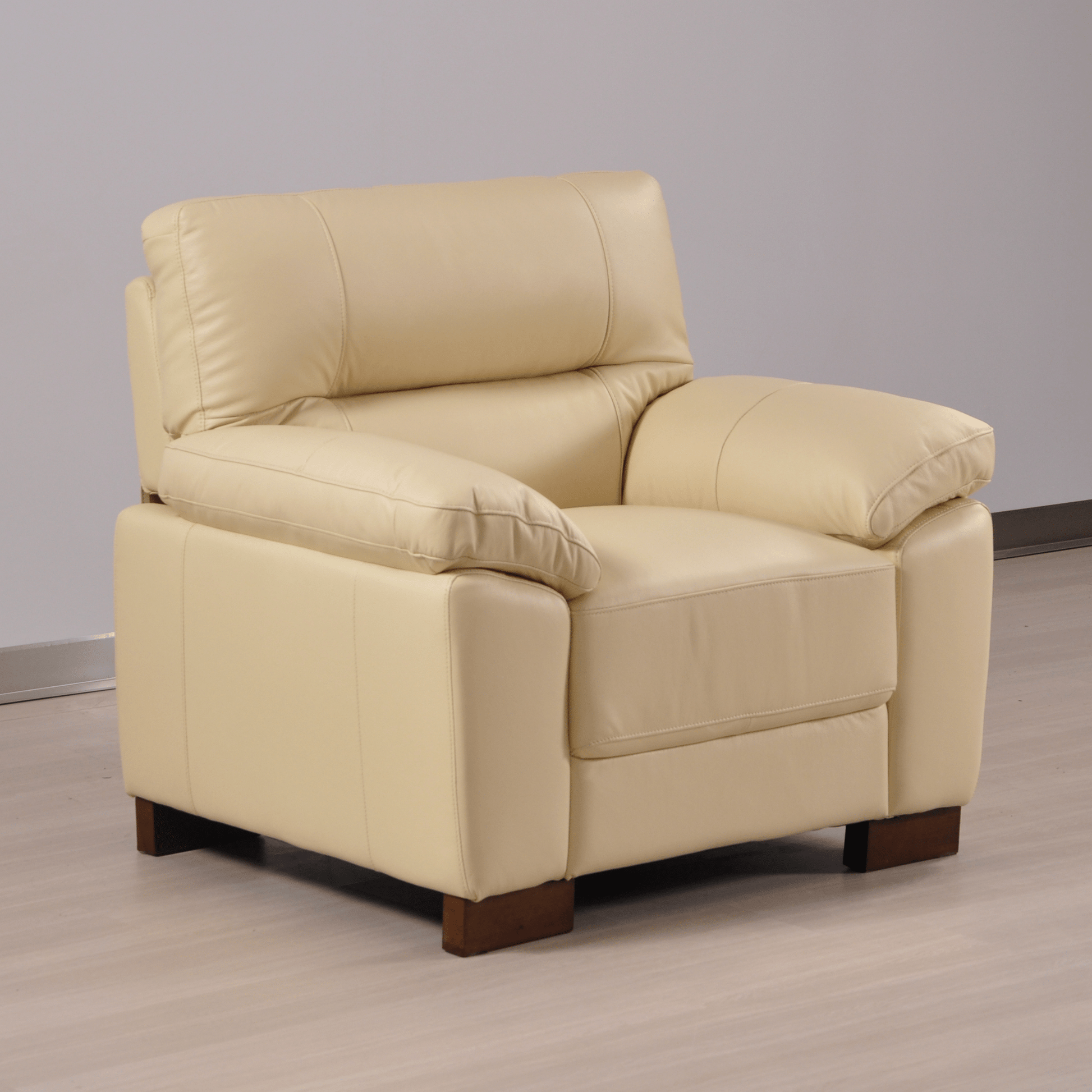 Cream armchair angled view in room setting with modern sleek design