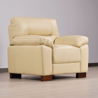 Cream armchair angled view in room setting with modern sleek design