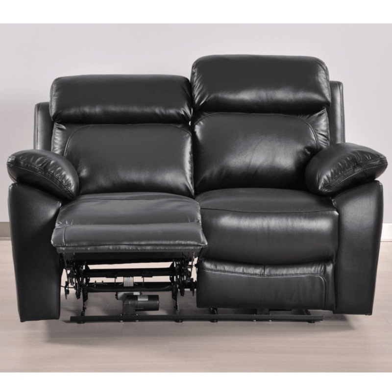Black leather recliner sofa on a light wooden floor with a neutral background