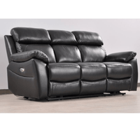 Black leather reclining sofa on a wooden floor with a white wall background