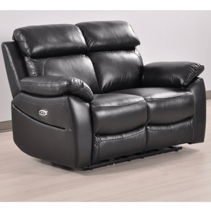 Black leather recliner sofa on a light wooden floor with a white wall background