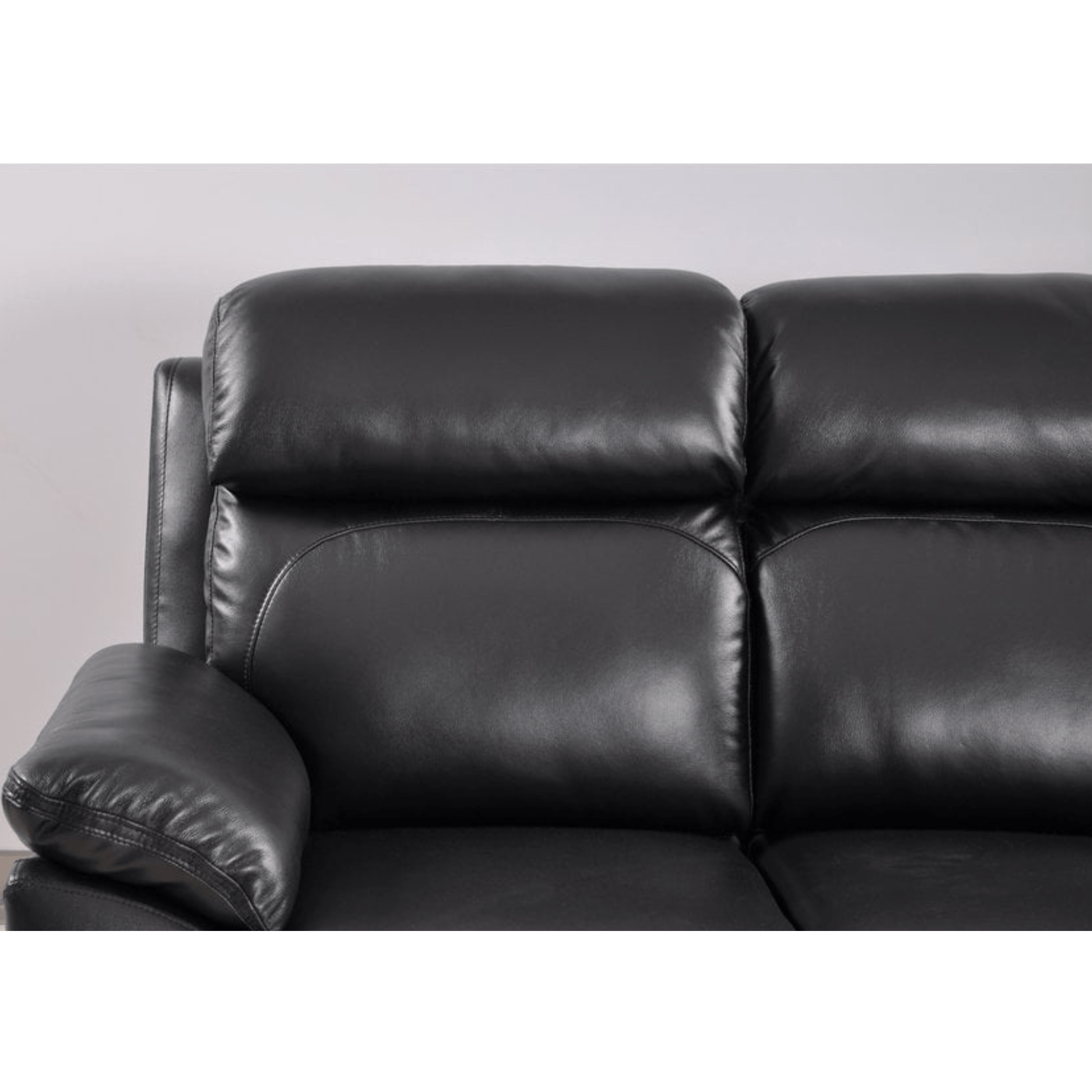 Black leather sofa against a plain background
