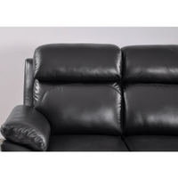 Black leather sofa against a plain background