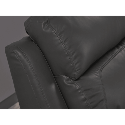 Close-up of a dark gray leather armchair with visible stitching.