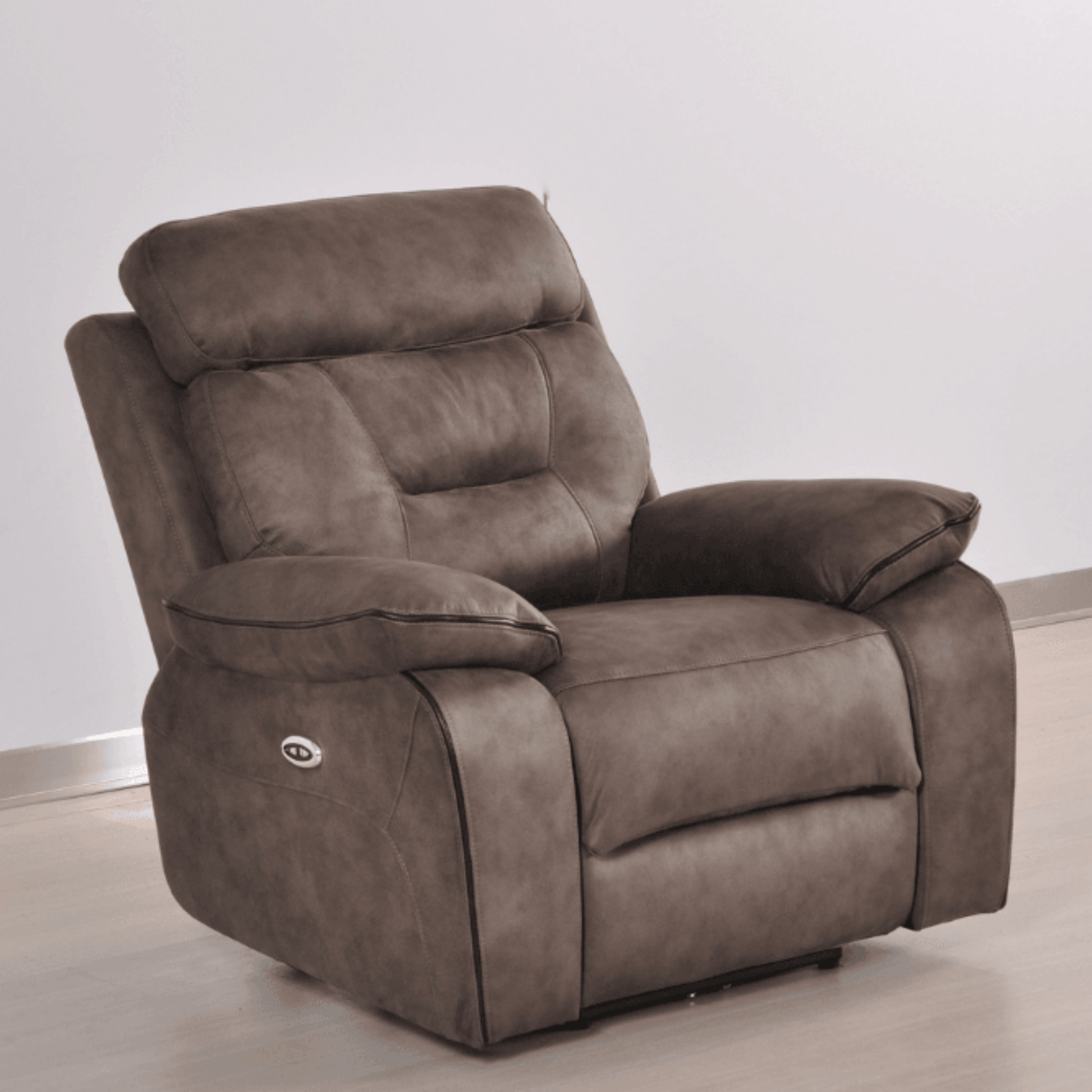 Brown recliner chair on a light wooden floor with a white wall background