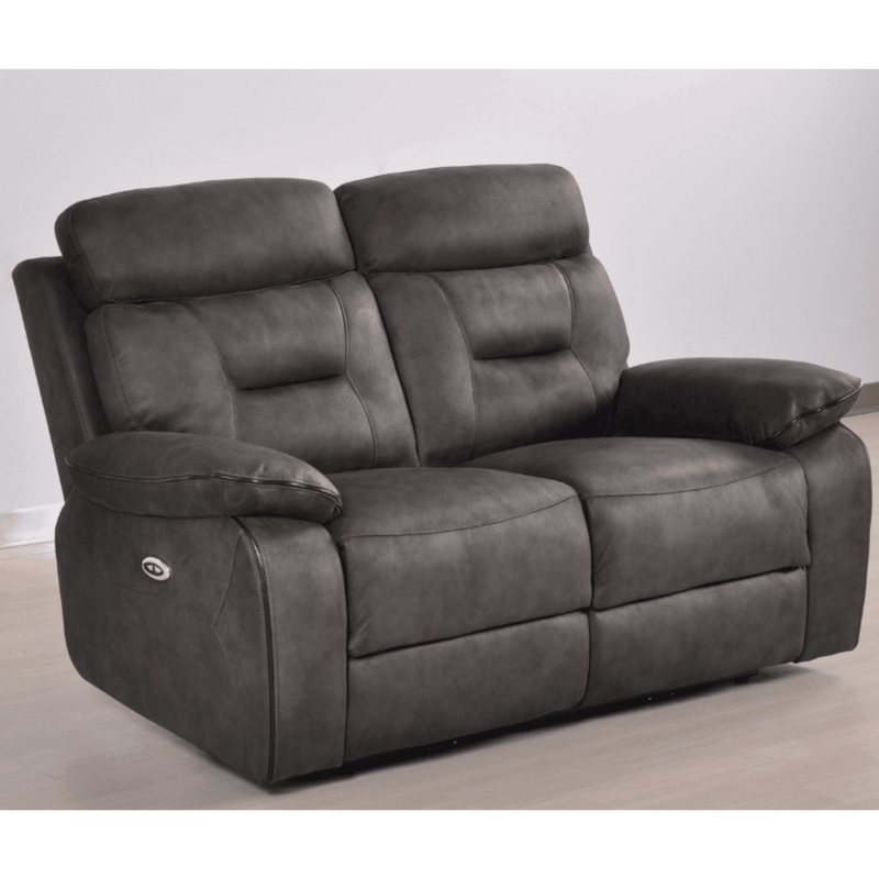 Gray reclining sofa on a light wooden floor with a white wall background