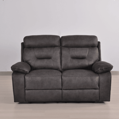 Gray leather sofa on a wooden floor with a plain white wall background