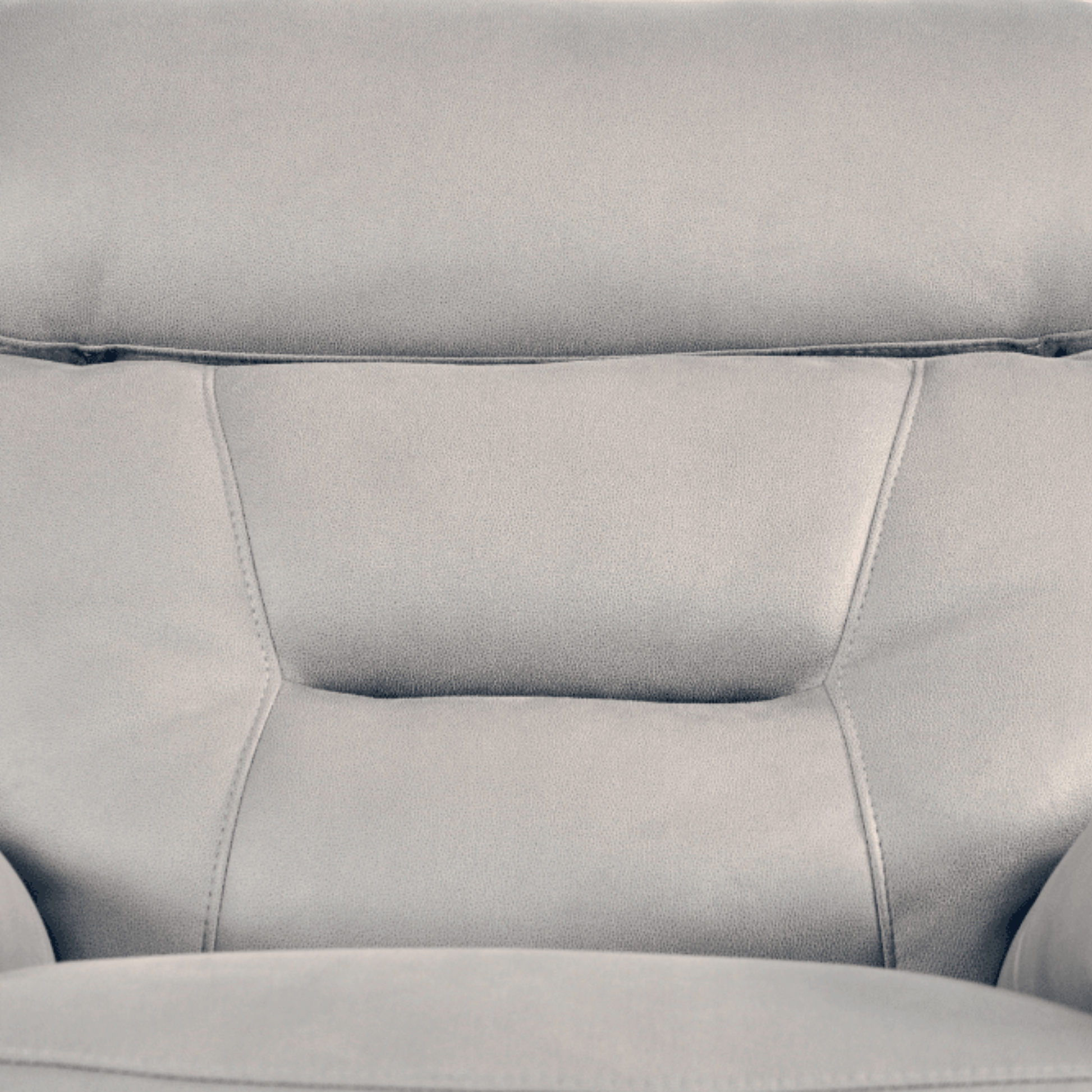 Close-up of a gray leather sofa with visible stitching