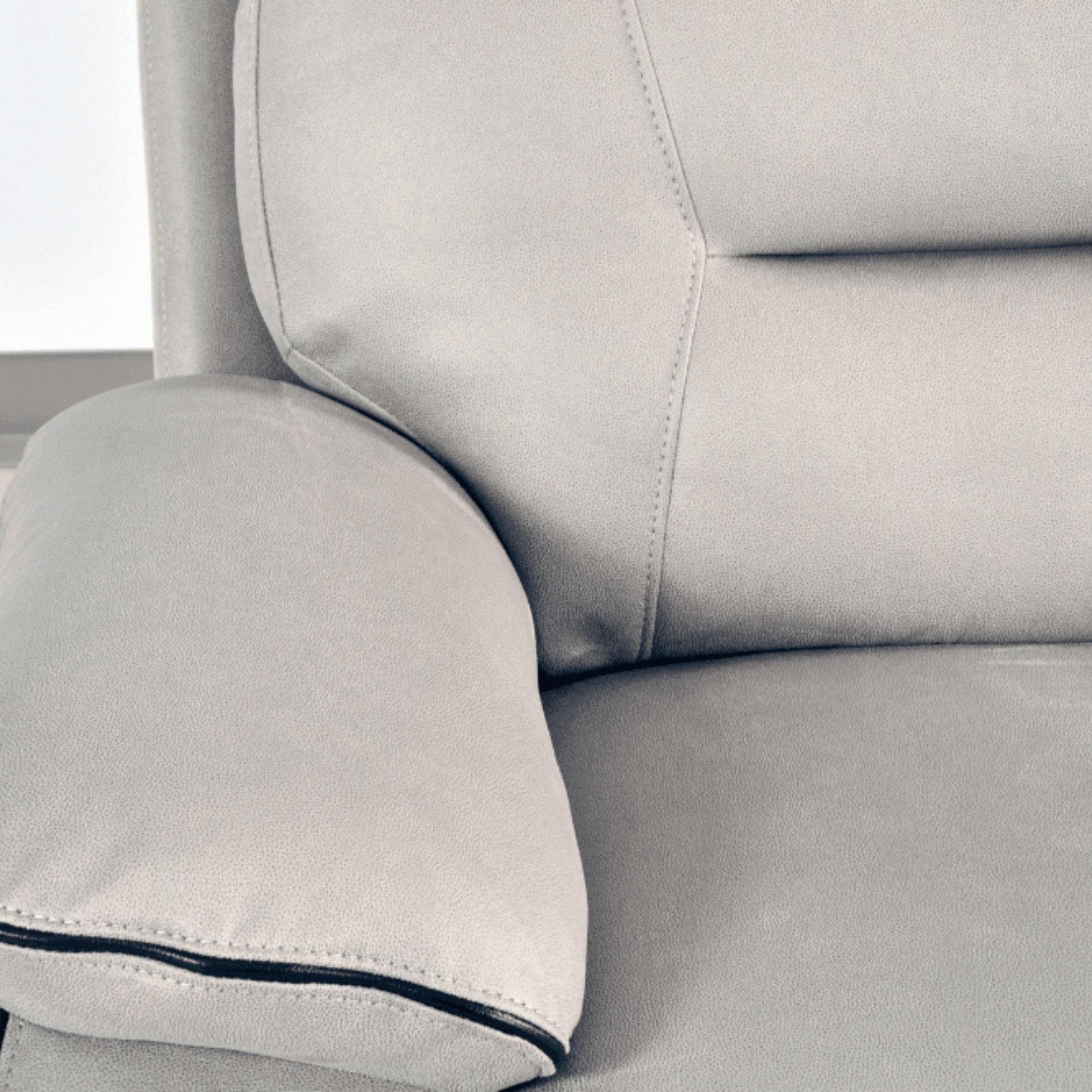 Close-up of a gray sofa with a pillow on a white background