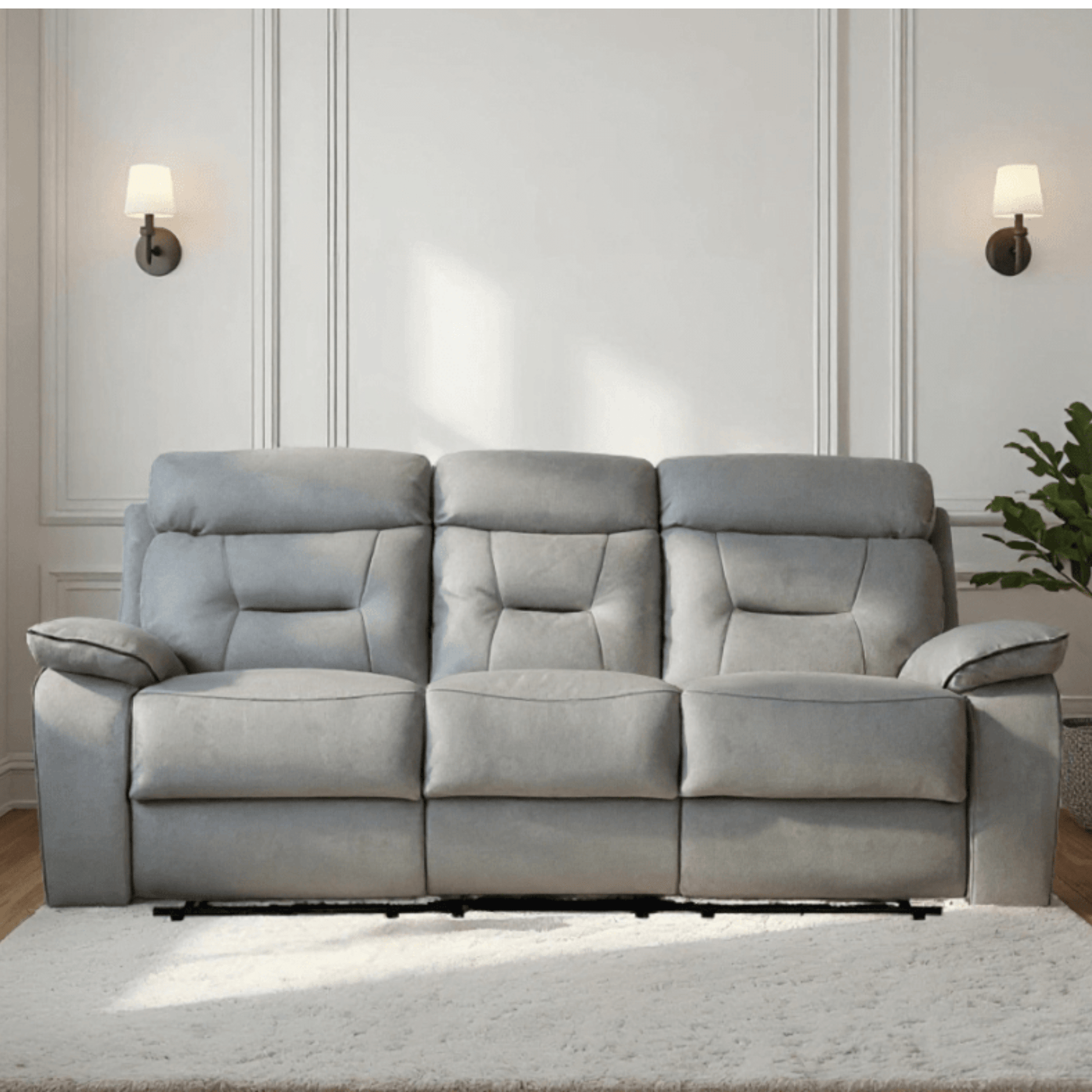 Gray sofa in a living room setting with a neutral wall and decor.