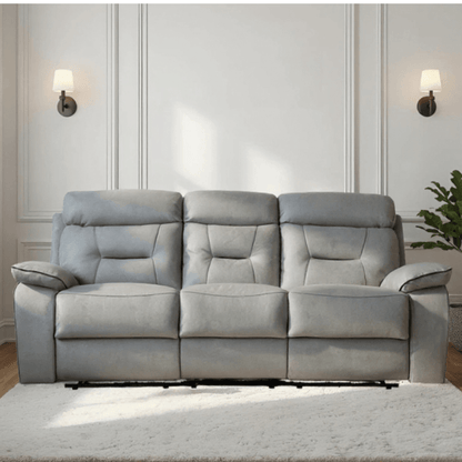 Gray sofa in a living room setting with a neutral wall and decor.