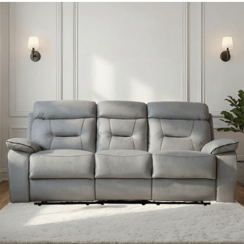 Gray sofa in a living room setting with a neutral wall and decor.