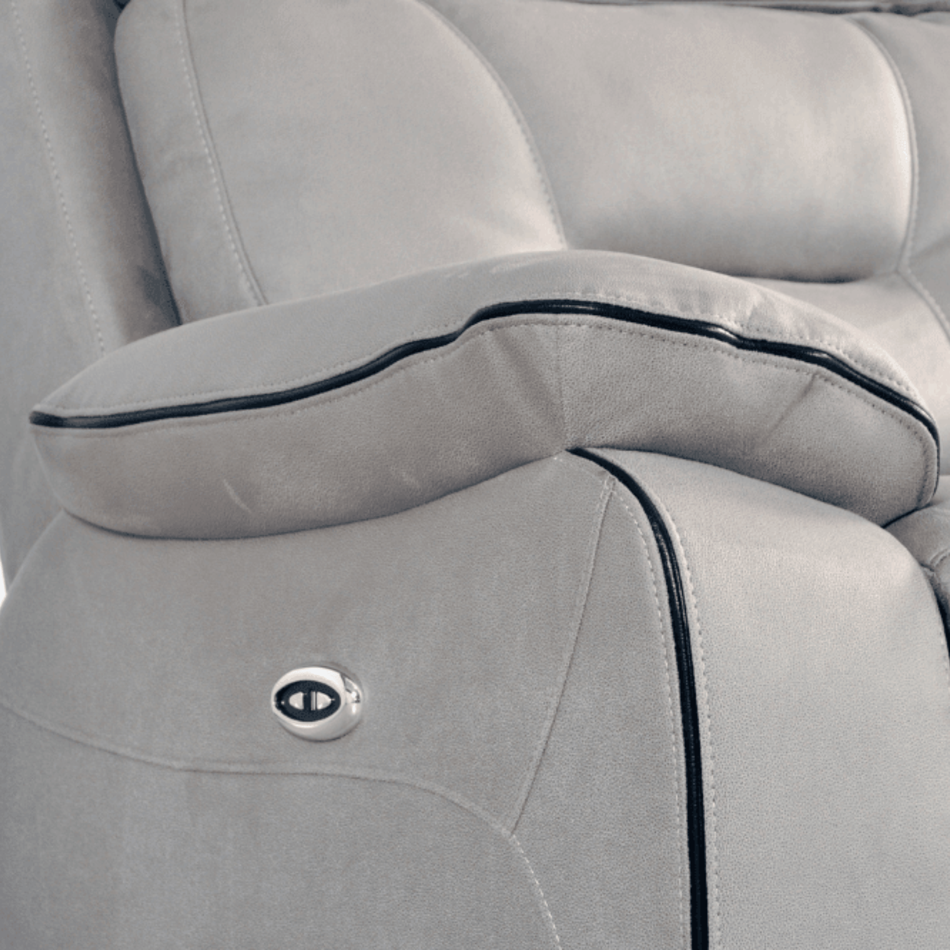 Close-up of a gray car seat with a visible brand logo.