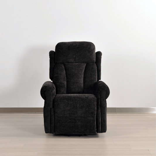 Dark gray recliner chair on a light wooden floor with a white wall background