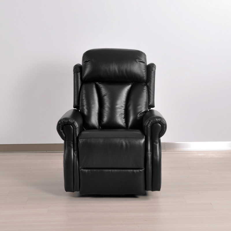Black leather recliner chair on a wooden floor with a white wall background