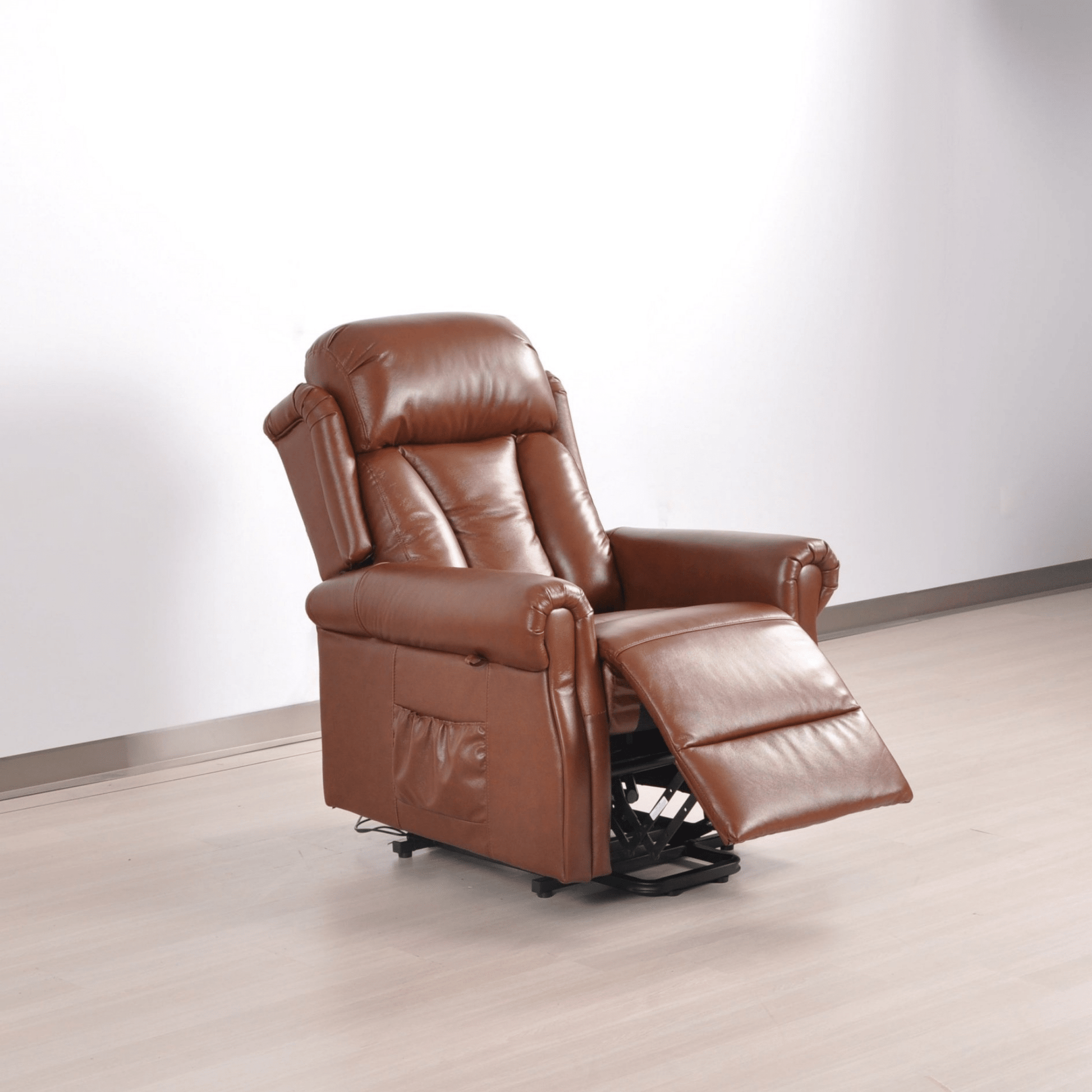 Brown leather recliner chair on a light wooden floor with a white wall background
