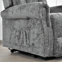 Gray fabric armchair with visible wear and tear on a light wooden floor.