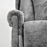 Close-up of a textured gray sofa with wooden armrest detail.