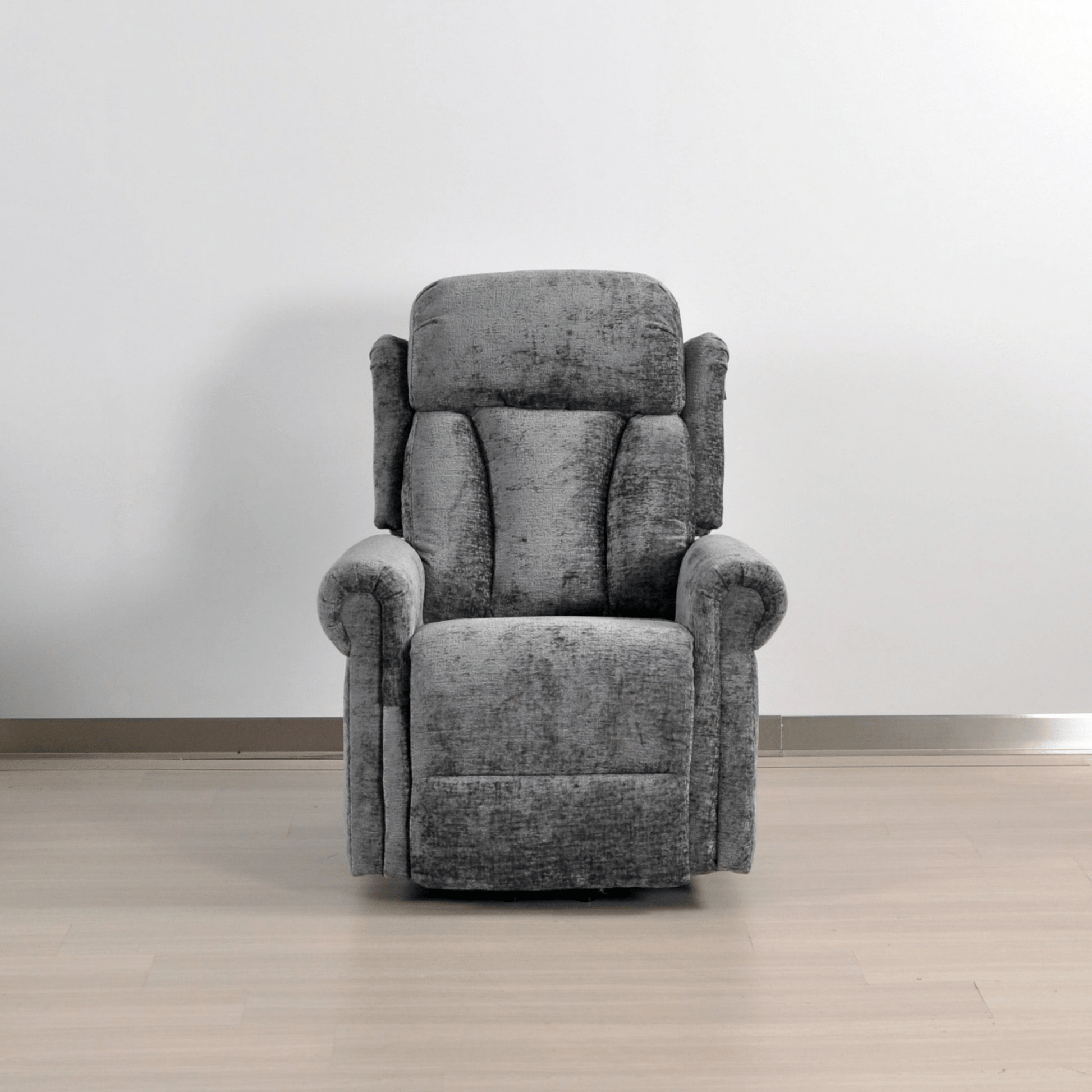 Gray recliner chair in a room with a plain background