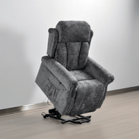 Gray recliner chair on a wooden floor with a white wall background