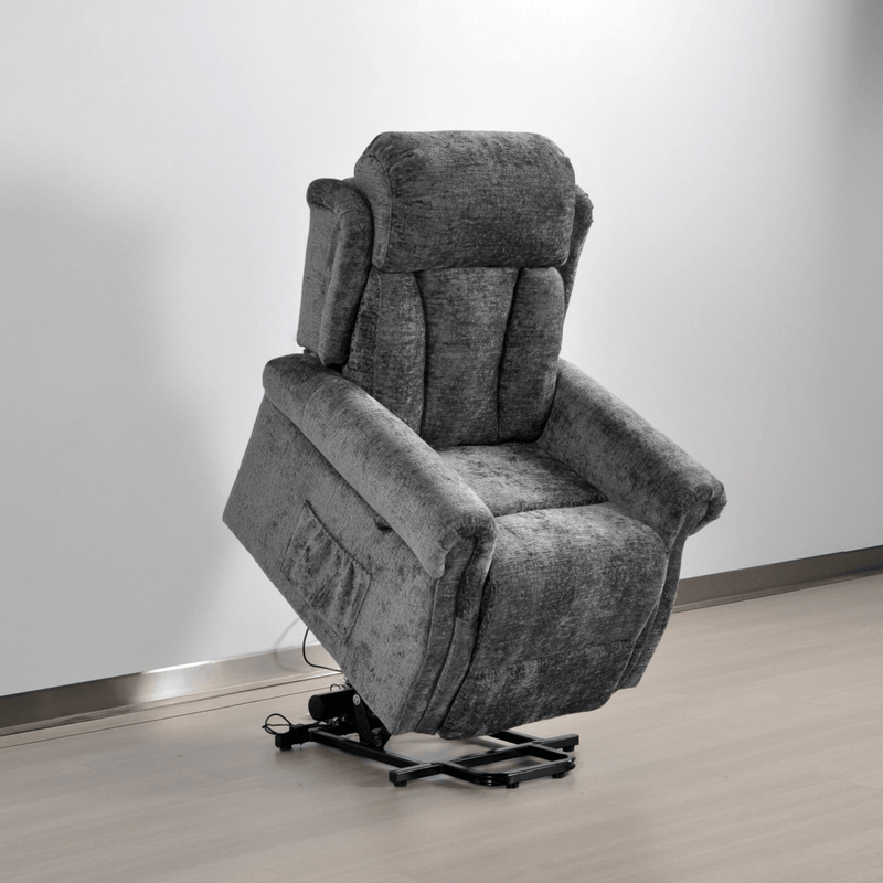 Gray recliner chair on a wooden floor with a white wall background