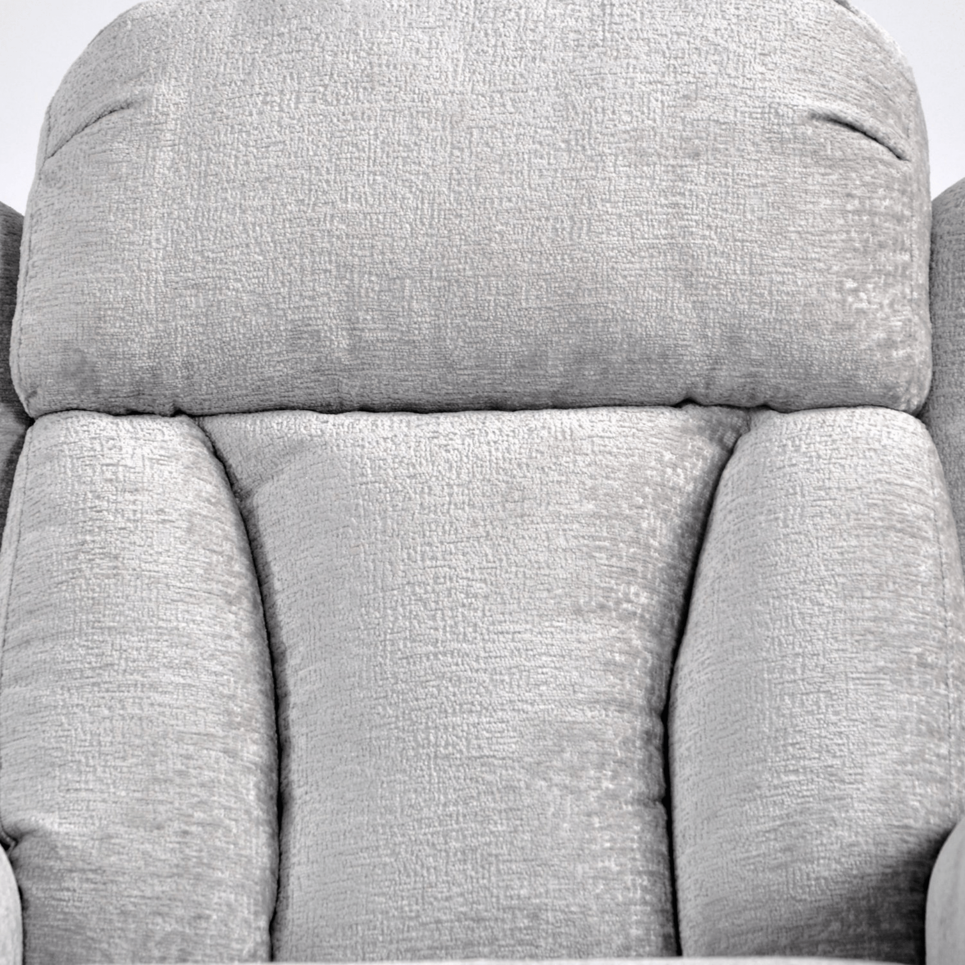 Close-up of a gray fabric armchair with a textured pattern.