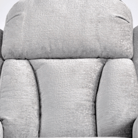 Close-up of a gray fabric armchair with a textured pattern.