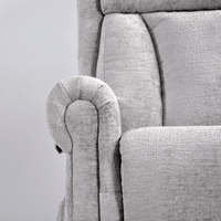 Close-up of a gray upholstered chair with a textured fabric finish.
