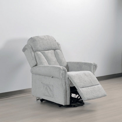 Gray recliner chair on a wooden floor with a white wall background