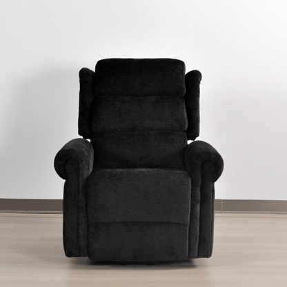 Black recliner chair on a light wooden floor with a white wall background