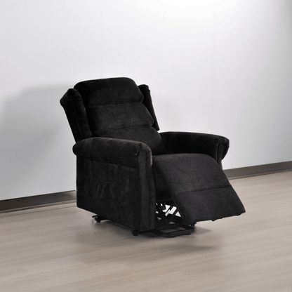 Black recliner chair on a wooden floor with a white wall background